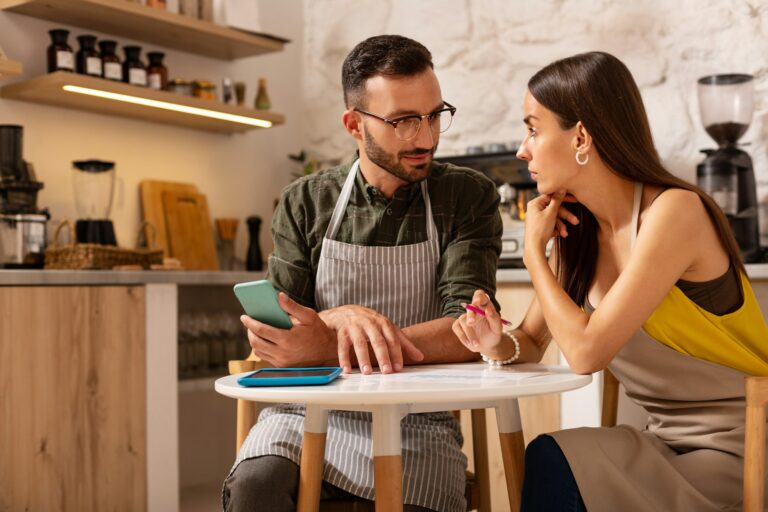 Couple having discussion while opening their own cafeteria